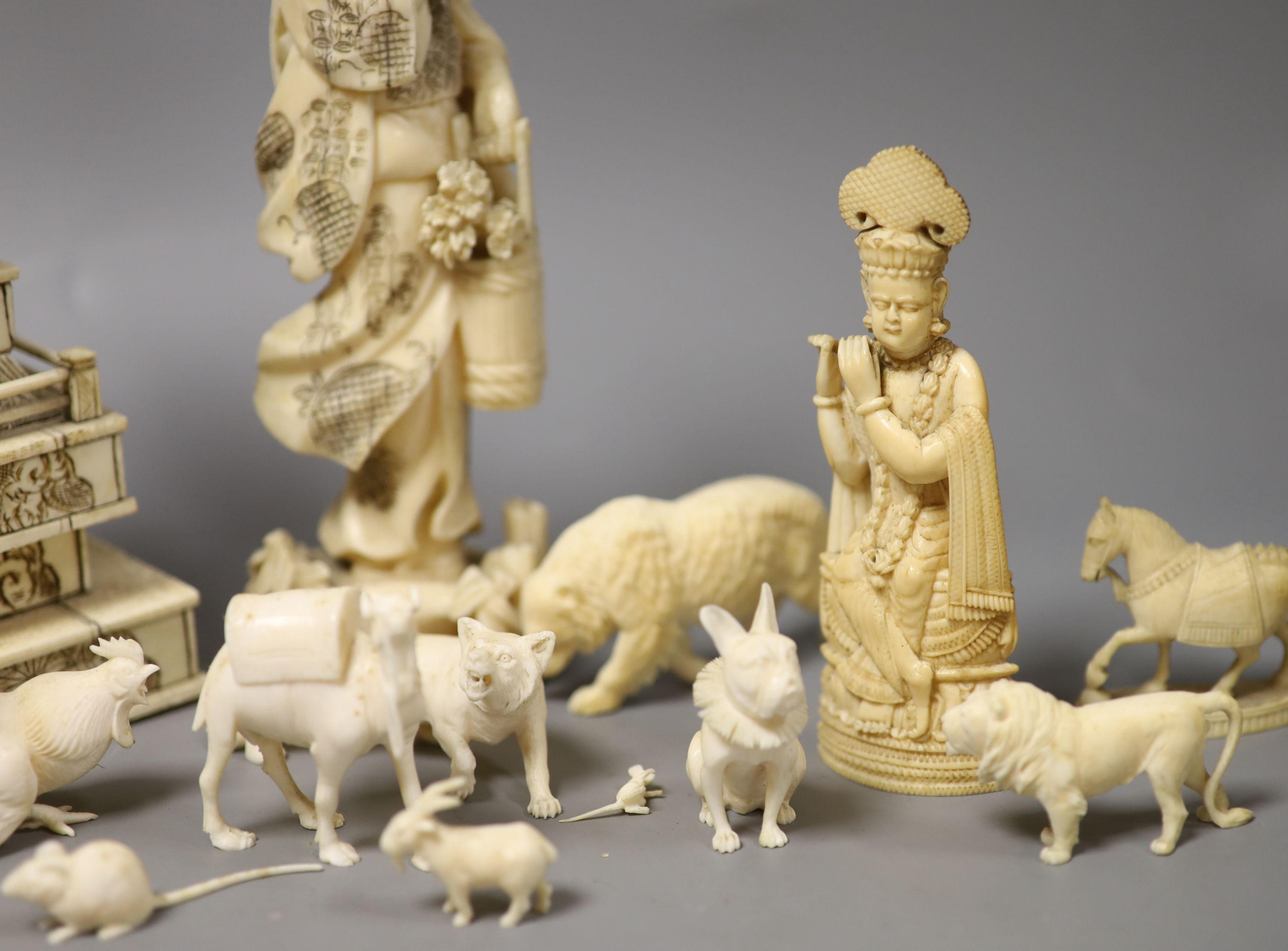 A Japanese Ivory model of a bijin, a similar model of a temple, various European Ivory models of animals and birds, an Indian Ivory figure et cetera, or late 19th or early 20th century